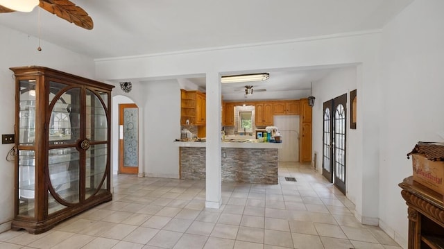 368 Riddle Rd, Cedar Creek, TX 78612 - kitchen with ceiling fan, french doors, and light tile patterned floors
