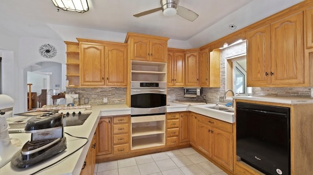 368 Riddle Rd, Cedar Creek, TX 78612 - kitchen with open shelves, black dishwasher, stainless steel oven, and decorative backsplash