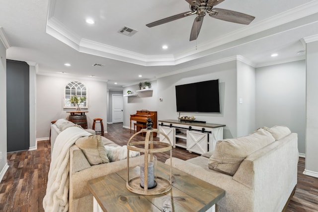 129 Bridgepoint, Onalaska, TX 77360 - living room featuring a raised ceiling, baseboards, ceiling fan, dark wood-style floors, and ornamental molding