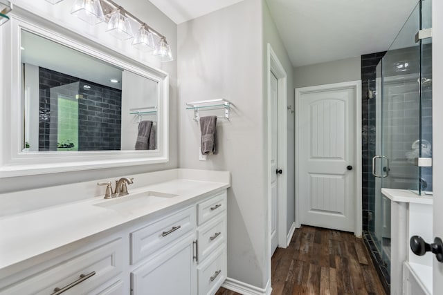 129 Bridgepoint, Onalaska, TX 77360 - full bath featuring vanity, a shower stall, and wood finished floors