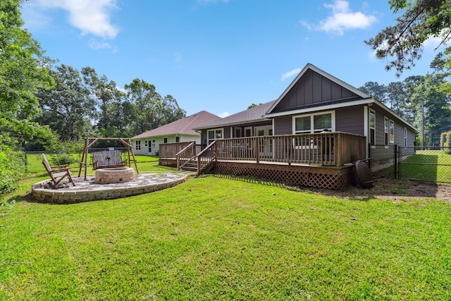 129 Bridgepoint, Onalaska, TX 77360 - back of property with an outdoor fire pit, board and batten siding, and a wooden deck