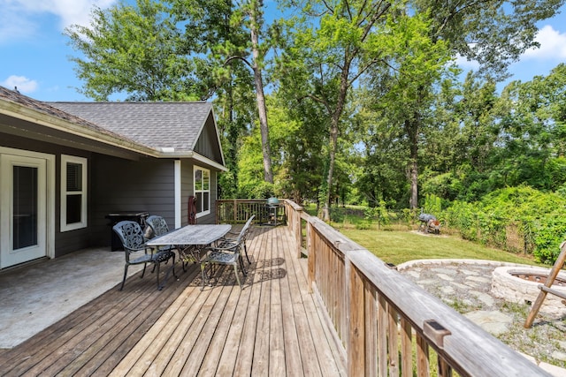 129 Bridgepoint, Onalaska, TX 77360 - wooden terrace featuring an outdoor fire pit and outdoor dining area