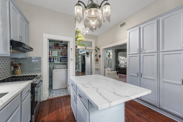 811 18th St, Galveston, TX 77550 - kitchen with stainless steel gas stove, under cabinet range hood, dark wood finished floors, a chandelier, and a center island