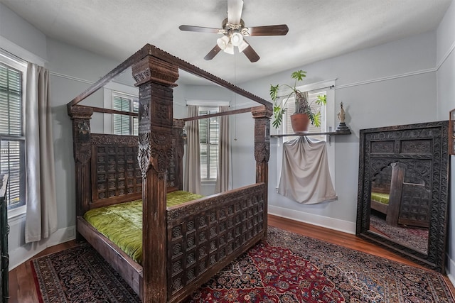 811 18th St, Galveston, TX 77550 - bedroom with wood finished floors, a ceiling fan, and a textured ceiling
