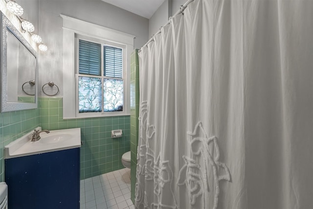 811 18th St, Galveston, TX 77550 - bathroom featuring vanity, tile walls, tile patterned flooring, and a wainscoted wall