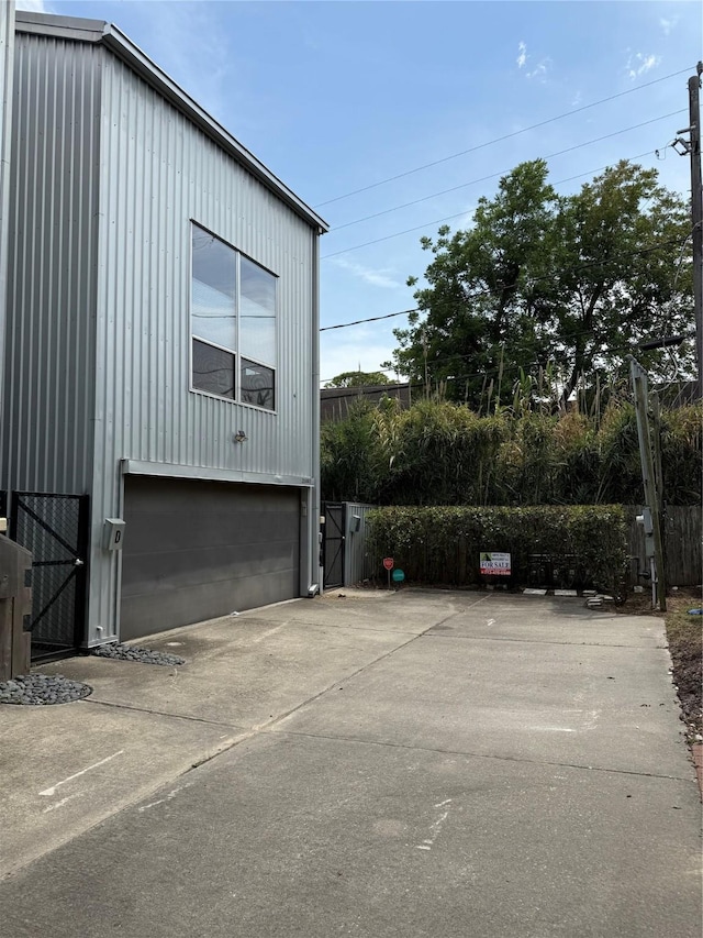 2508 Calumet St Unit E, Houston, TX 77004 - view of side of home featuring a garage and concrete driveway