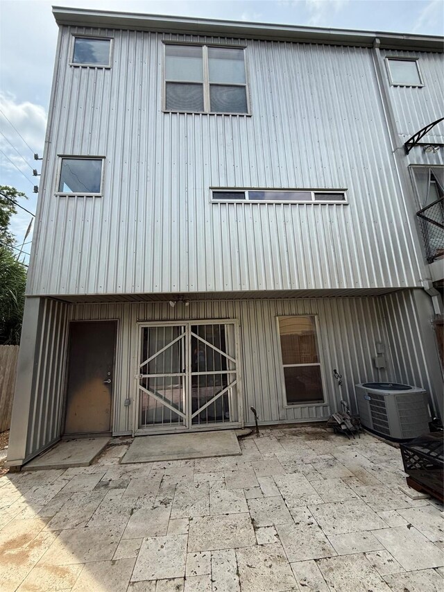 2508 Calumet St Unit E, Houston, TX 77004 - rear view of house with a patio area and board and batten siding
