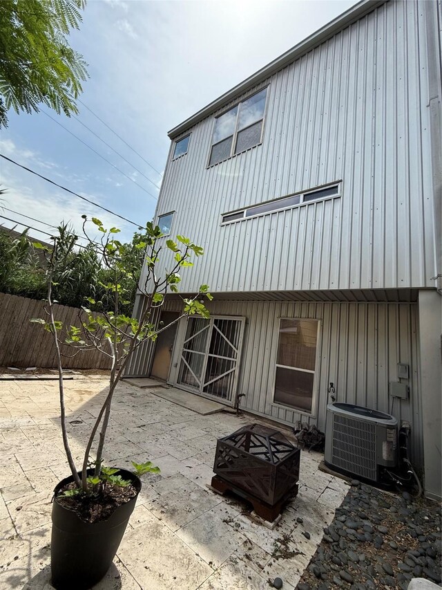 2508 Calumet St Unit E, Houston, TX 77004 - back of property with a fire pit, board and batten siding, and a patio area