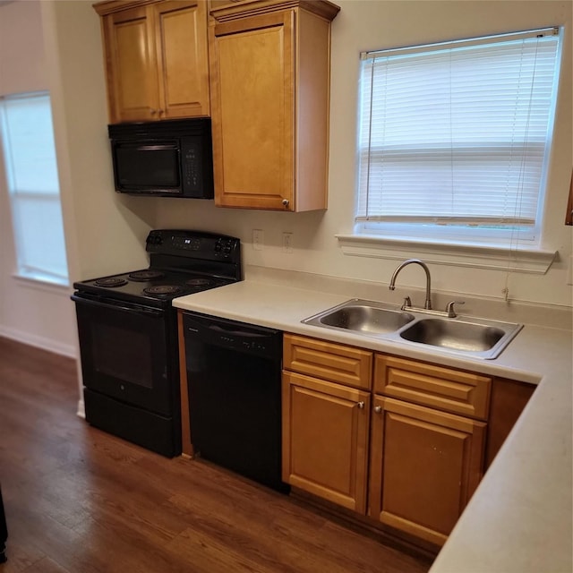322 7th Ave N, Texas City, TX 77590 - kitchen featuring black appliances, a sink, dark wood finished floors, and light countertops