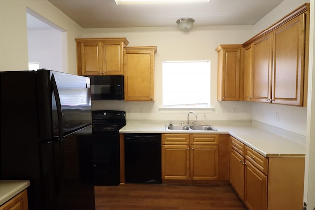 322 7th Ave N, Texas City, TX 77590 - kitchen featuring black appliances, a sink, dark wood-style floors, and light countertops