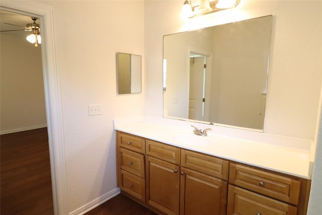 322 7th Ave N, Texas City, TX 77590 - bathroom featuring vanity, wood finished floors, a ceiling fan, and baseboards