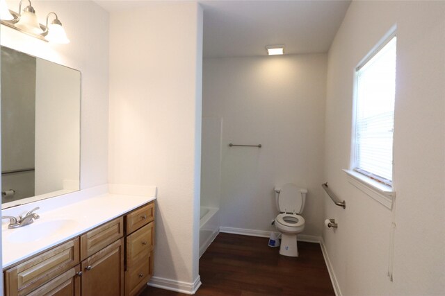 322 7th Ave N, Texas City, TX 77590 - bathroom featuring toilet, vanity, wood finished floors, and baseboards
