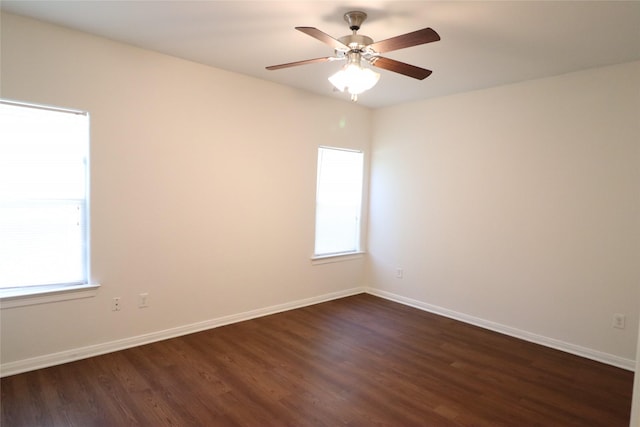 322 7th Ave N, Texas City, TX 77590 - empty room with dark wood finished floors, plenty of natural light, and baseboards