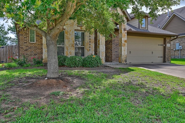 2209 Parker Ct, Brenham, TX 77833 - view of property hidden behind natural elements with stone siding, a garage, concrete driveway, and a shingled roof