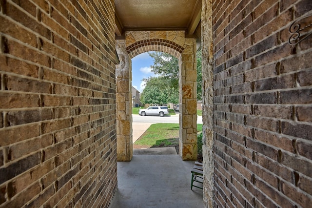 2209 Parker Ct, Brenham, TX 77833 - doorway to outside featuring concrete flooring and brick wall