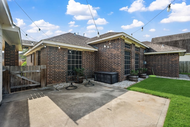 6710 Canyon Trl, Manvel, TX 77578 - back of house featuring roof with shingles, a patio, and brick siding