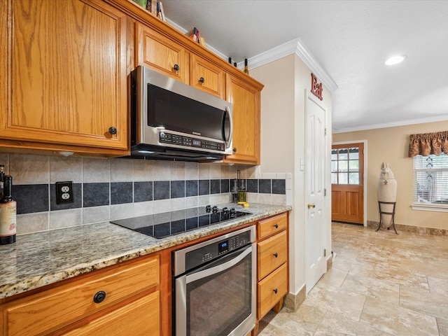 136 Fantail St, Magnolia, TX 77355 - kitchen with stainless steel appliances, baseboards, ornamental molding, brown cabinetry, and backsplash