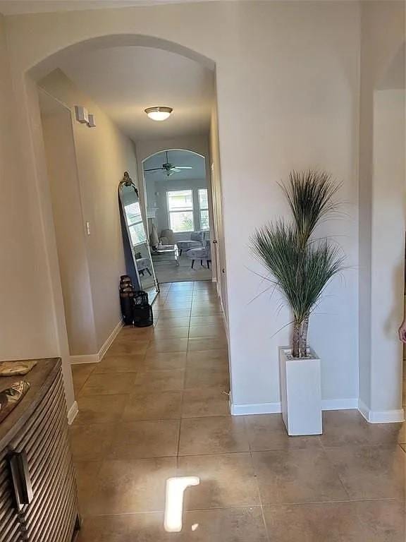 17023 Tallgrass Prairie Ln, Humble, TX 77346 - hall featuring arched walkways, tile patterned flooring, and baseboards