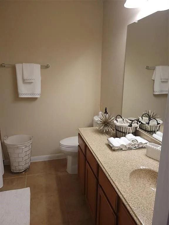 17023 Tallgrass Prairie Ln, Humble, TX 77346 - bathroom with toilet, vanity, tile patterned floors, and baseboards