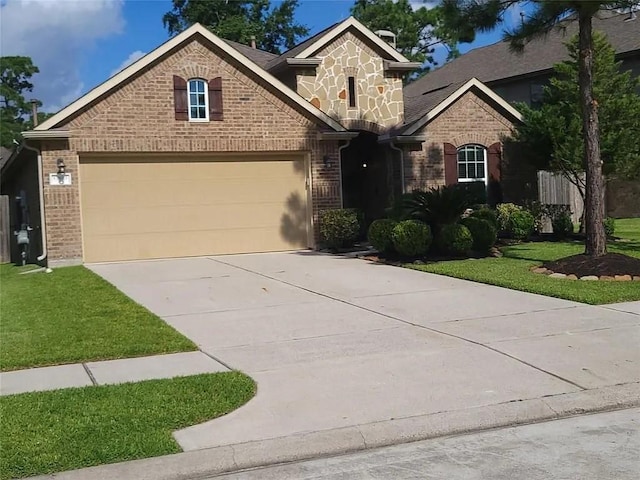 17023 Tallgrass Prairie Ln, Humble, TX 77346 - view of front of house with brick siding, concrete driveway, an attached garage, and a front yard