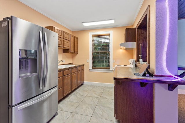 2616 45th St, Galveston, TX 77550 - kitchen with stainless steel refrigerator with ice dispenser, a sink, baseboards, light countertops, and crown molding