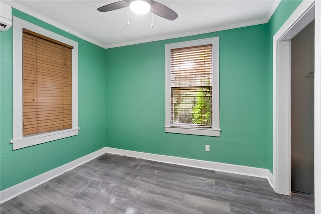 2616 45th St, Galveston, TX 77550 - unfurnished bedroom with wood finished floors, ornamental molding, baseboards, ceiling fan, and a wall mounted air conditioner