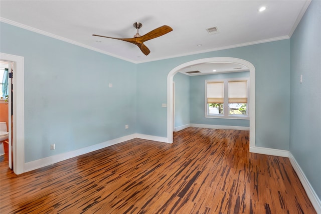 2616 45th St, Galveston, TX 77550 - unfurnished room featuring arched walkways, ceiling fan, wood finished floors, baseboards, and crown molding