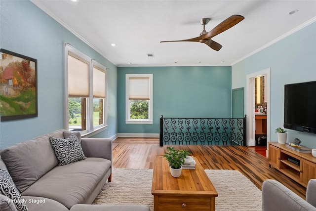 2616 45th St, Galveston, TX 77550 - living room with ornamental molding, wood finished floors, ceiling fan, baseboards, and recessed lighting
