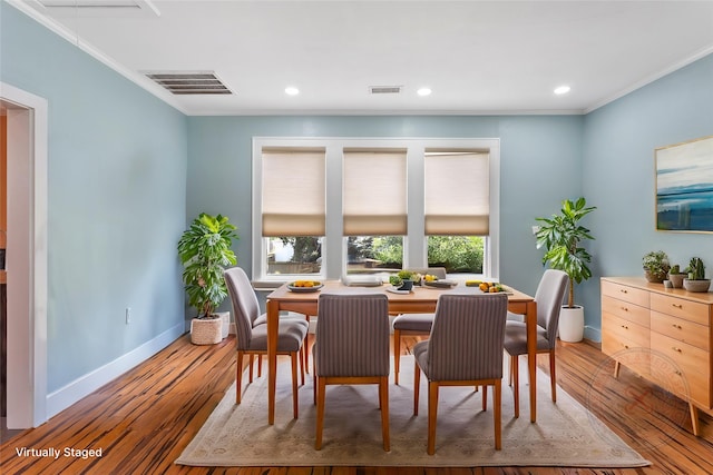 2616 45th St, Galveston, TX 77550 - dining area featuring crown molding, baseboards, wood finished floors, attic access, and recessed lighting