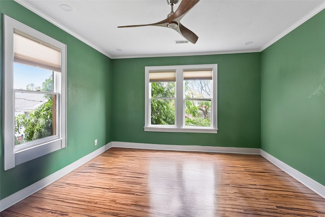 2616 45th St, Galveston, TX 77550 - unfurnished room with healthy amount of natural light, wood finished floors, ornamental molding, and baseboards