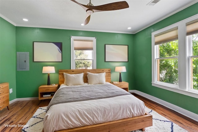 2616 45th St, Galveston, TX 77550 - bedroom featuring electric panel, baseboards, ornamental molding, multiple windows, and recessed lighting