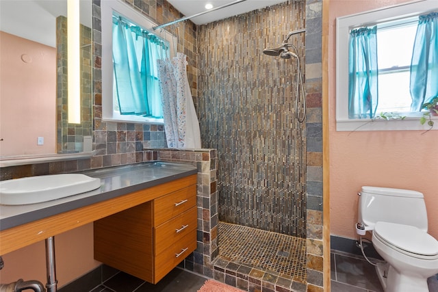 2616 45th St, Galveston, TX 77550 - full bathroom with toilet, tiled shower, vanity, and tile patterned floors