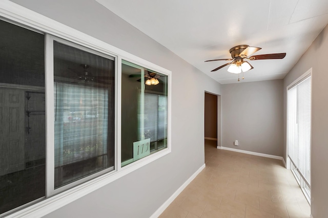 12633 Memorial Dr Unit 179, Houston, TX 77024 - spare room with a ceiling fan, baseboards, and light tile patterned floors