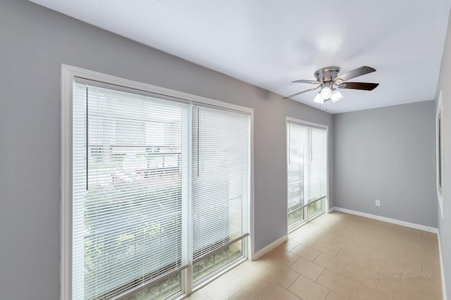 12633 Memorial Dr Unit 179, Houston, TX 77024 - empty room with a ceiling fan, baseboards, and light tile patterned floors