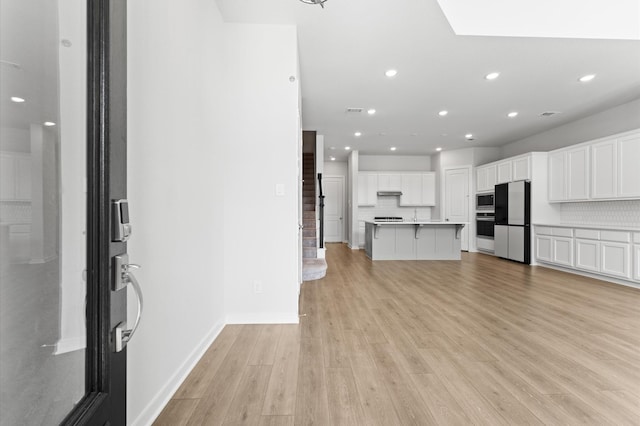 16514 Lake Austin St, Cypress, TX 77433 - kitchen featuring stainless steel appliances, light wood finished floors, white cabinetry, recessed lighting, and light countertops