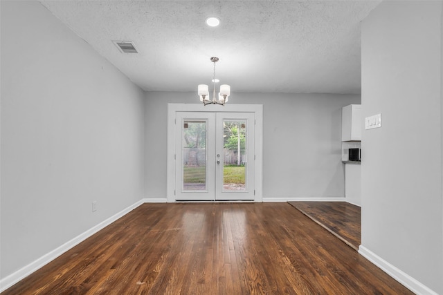 2032 Vince St, Pasadena, TX 77502 - unfurnished dining area with a chandelier, wood finished floors, baseboards, and a textured ceiling