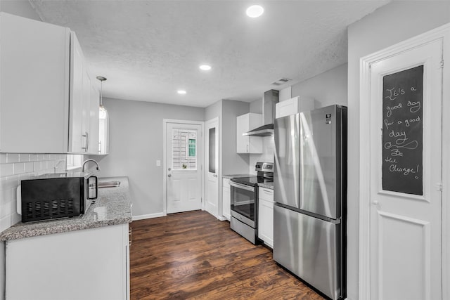 2032 Vince St, Pasadena, TX 77502 - kitchen featuring appliances with stainless steel finishes, dark wood finished floors, wall chimney exhaust hood, recessed lighting, and tasteful backsplash