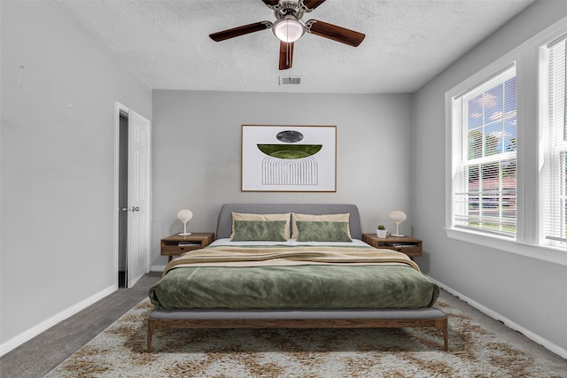 2032 Vince St, Pasadena, TX 77502 - bedroom with carpet floors, a textured ceiling, multiple windows, baseboards, and a ceiling fan