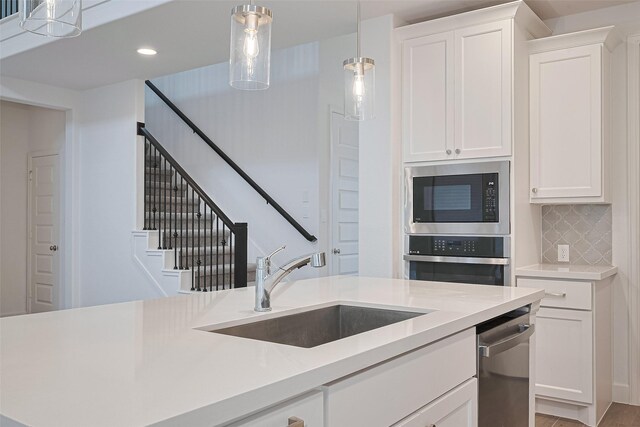 30351 Spragletop View St, Brookshire, TX 77423 - kitchen with stainless steel appliances, a sink, light countertops, decorative light fixtures, and recessed lighting