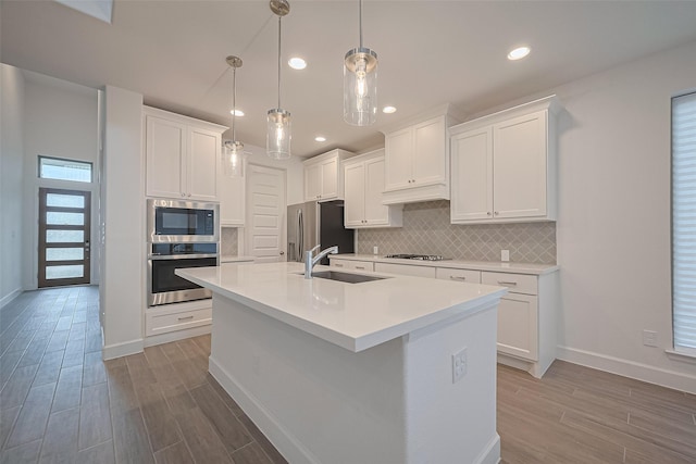 30351 Spragletop View St, Brookshire, TX 77423 - kitchen with stainless steel appliances, a sink, wood finished floors, baseboards, and recessed lighting