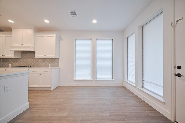 30351 Spragletop View St, Brookshire, TX 77423 - kitchen featuring light countertops, white cabinets, baseboards, tasteful backsplash, and recessed lighting