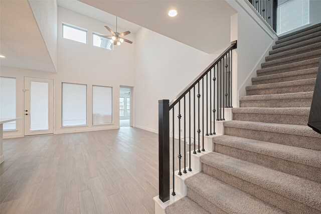 30351 Spragletop View St, Brookshire, TX 77423 - staircase with a ceiling fan, wood finished floors, a towering ceiling, baseboards, and recessed lighting