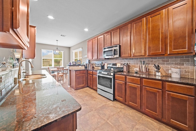 13526 Astley Acres Ln, Cypress, TX 77429 - kitchen featuring appliances with stainless steel finishes, a sink, brown cabinetry, and recessed lighting