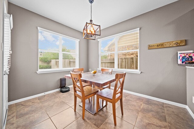 13526 Astley Acres Ln, Cypress, TX 77429 - dining room featuring a chandelier, baseboards, and tile patterned flooring