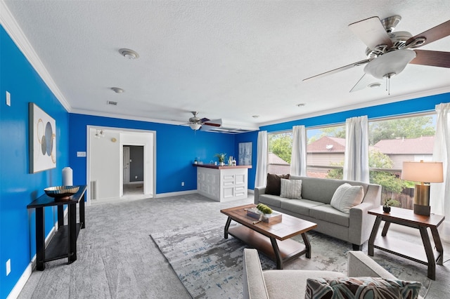 20234 Brondesbury Dr, Katy, TX 77450 - carpeted living area with a ceiling fan, crown molding, a textured ceiling, and baseboards