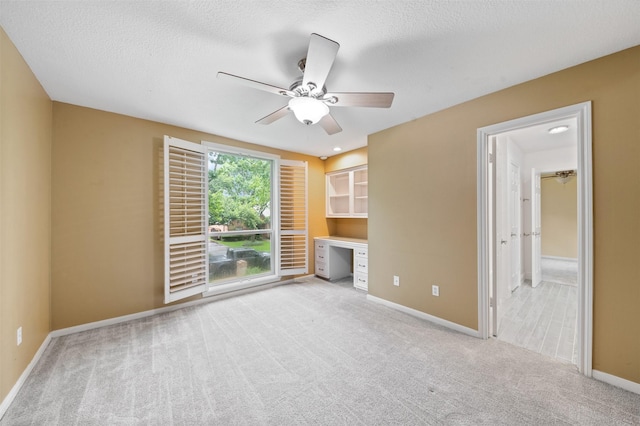 20234 Brondesbury Dr, Katy, TX 77450 - unfurnished living room with carpet floors, ceiling fan, baseboards, and a textured ceiling