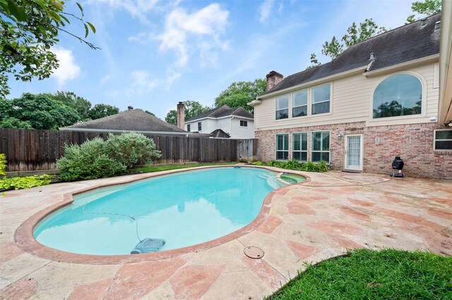 20234 Brondesbury Dr, Katy, TX 77450 - view of swimming pool featuring a fenced backyard, a patio, and a pool with connected hot tub