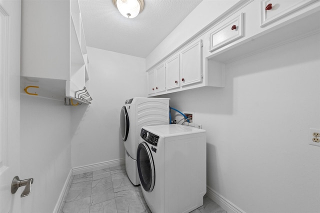 20234 Brondesbury Dr, Katy, TX 77450 - laundry area with light marble finish floors, separate washer and dryer, cabinet space, a textured ceiling, and baseboards