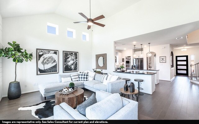 12106 Hollow Marsh Dr, Santa Fe, TX 77510 - living room with dark wood finished floors, arched walkways, ceiling fan, baseboards, and a high ceiling