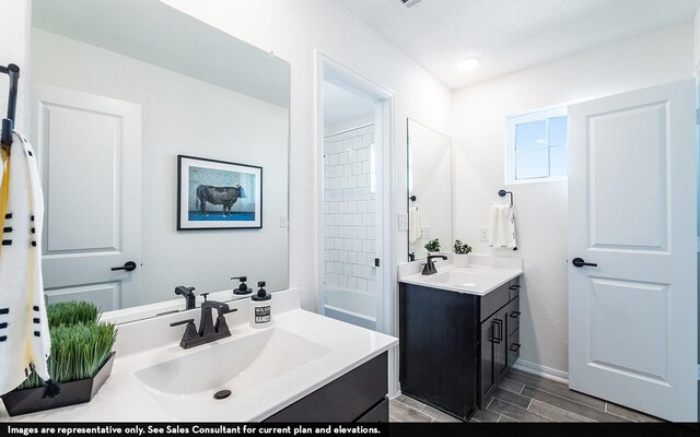 12106 Hollow Marsh Dr, Santa Fe, TX 77510 - bathroom with two vanities, wood finished floors, and bathtub / shower combination